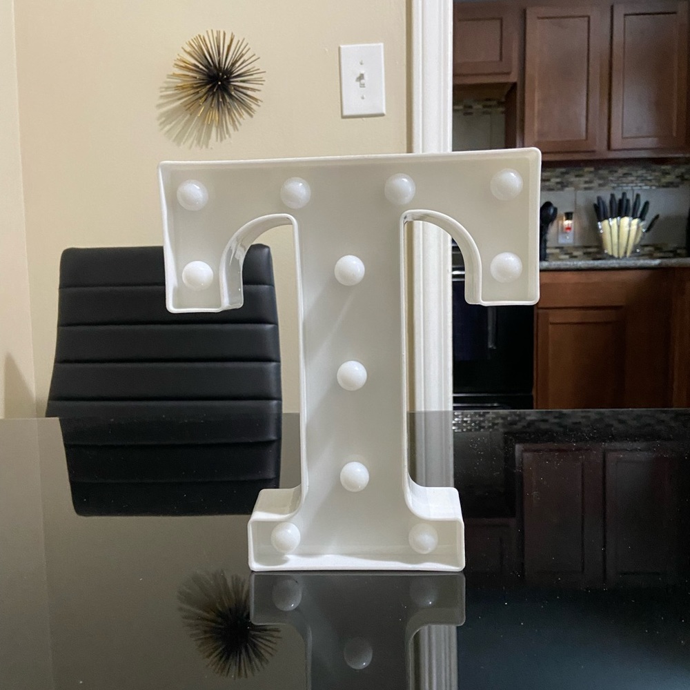 Marquee letter “T” with lights